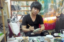 Họa sĩ Đậu Quang Thành đang vẽ tranh 3D trên đá.